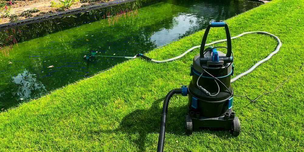 zwemvijver onderhoud met reinigingsapparatuur op gazon